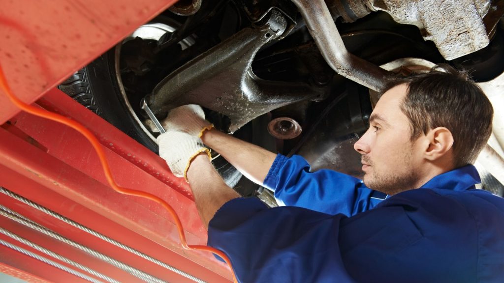 mechanic fixing wheel alignment